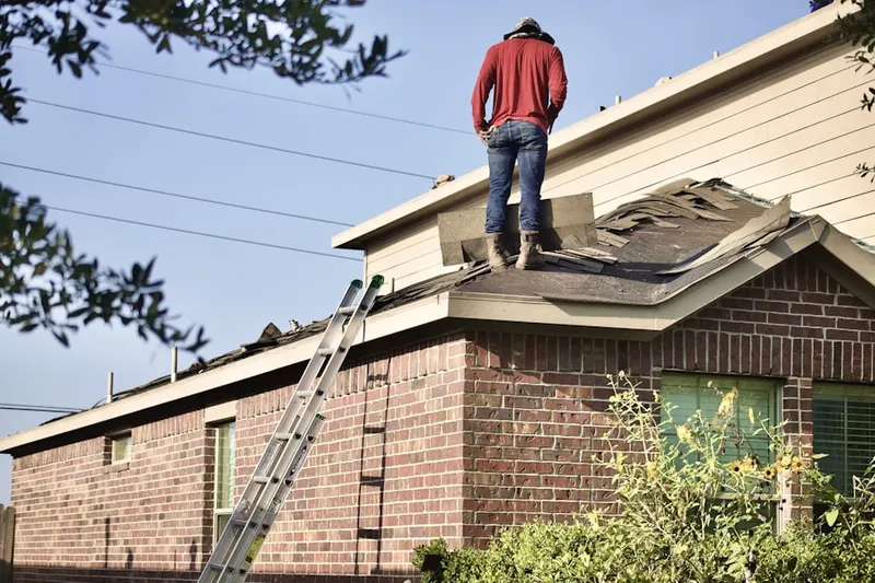 Professional roofer working on a residential roof in York Center